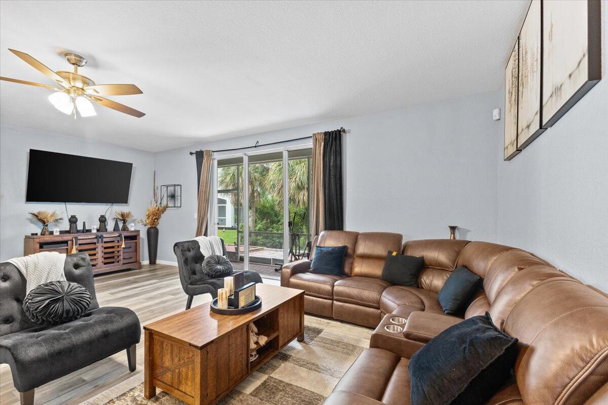 2227 Oakmont Drive Riviera Beach, FL 33404 - Photo 13 of 43 a living room with furniture and a flat screen tv