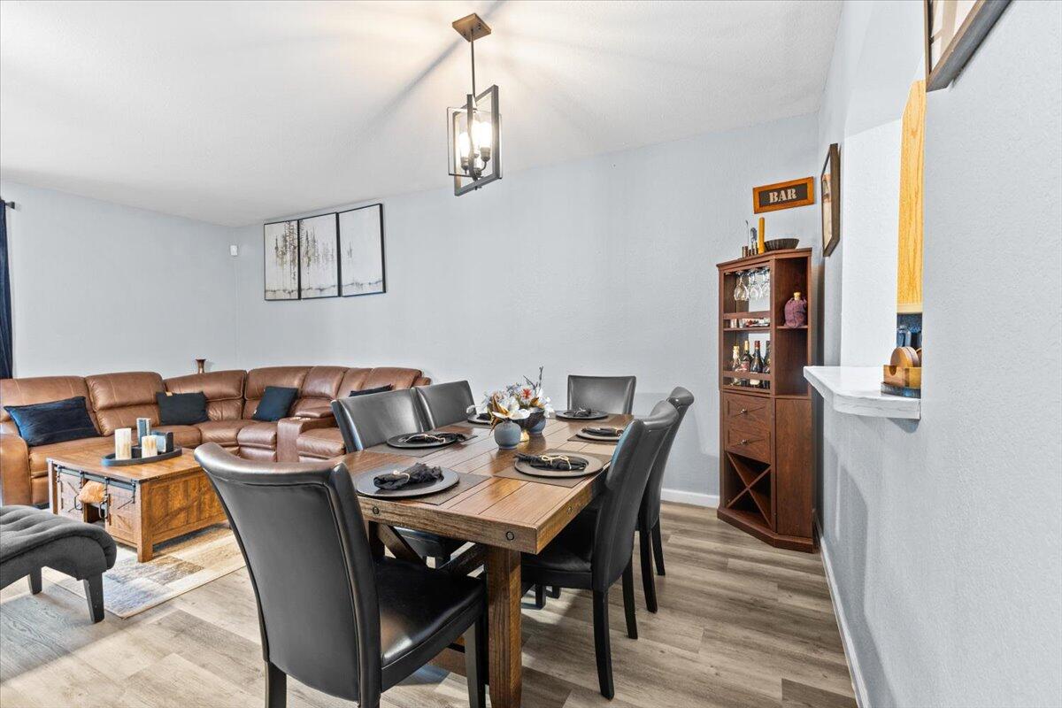 2227 Oakmont Drive Riviera Beach, FL 33404 - Photo 14 of 43 a view of a dining room with furniture and wooden floor