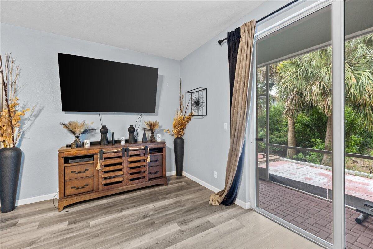 2227 Oakmont Drive Riviera Beach, FL 33404 - Photo 17 of 43 a room with furniture and a flat screen tv