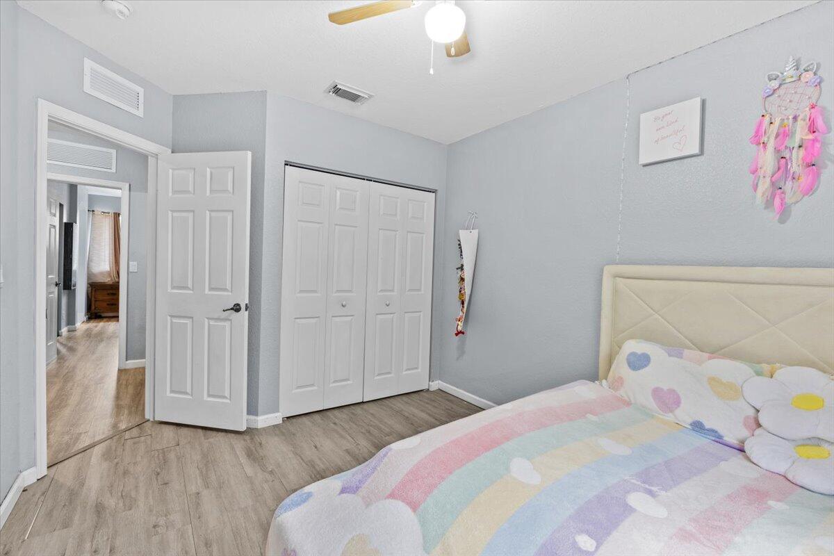 2227 Oakmont Drive Riviera Beach, FL 33404 - Photo 28 of 43 a bedroom with a bed and a chandelier