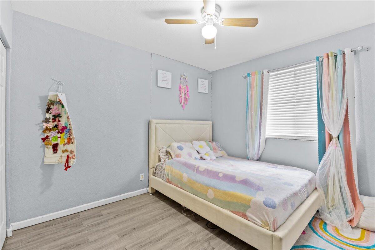 2227 Oakmont Drive Riviera Beach, FL 33404 - Photo 29 of 43 a bedroom with a bed and a window
