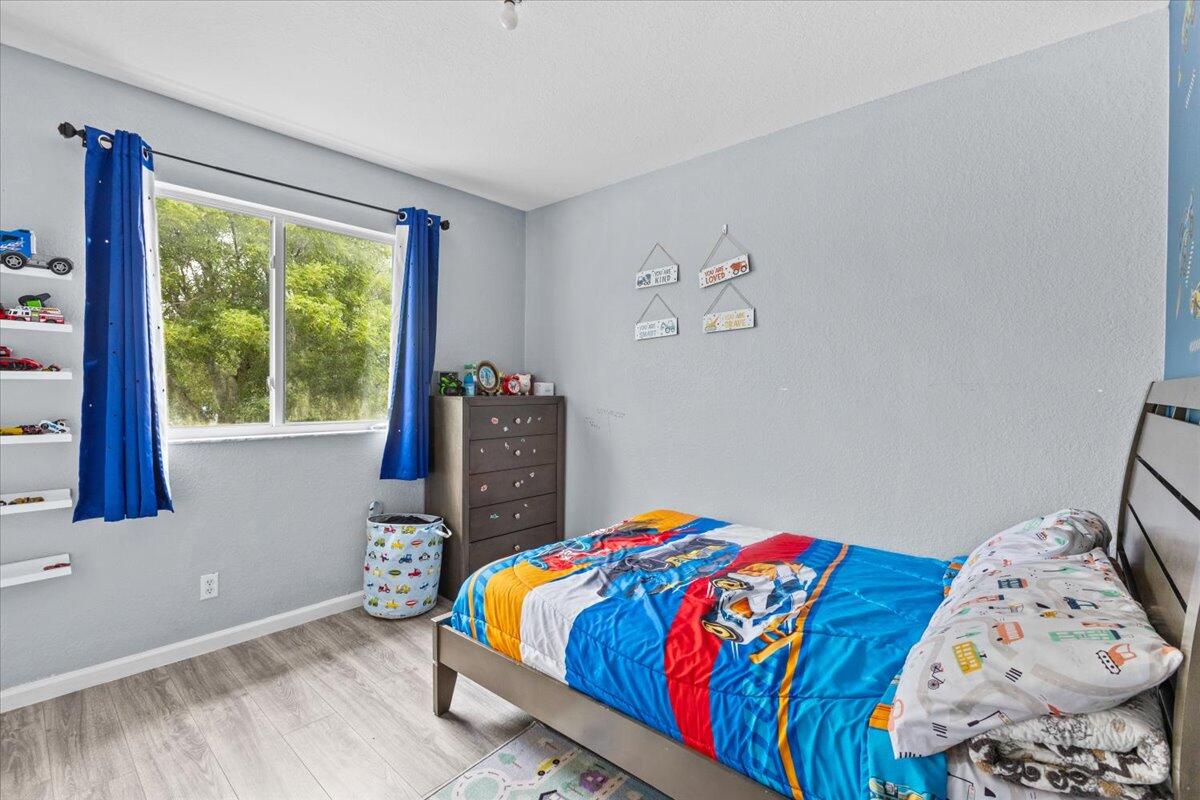 2227 Oakmont Drive Riviera Beach, FL 33404 - Photo 30 of 43 a bedroom with a bed and a window