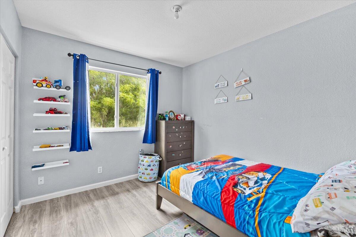 2227 Oakmont Drive Riviera Beach, FL 33404 - Photo 32 of 43 a bedroom with a bed and a window