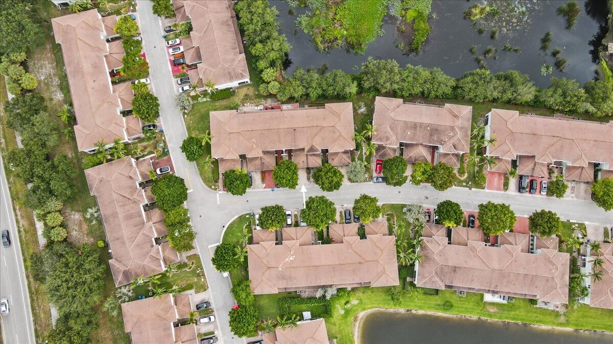 2227 Oakmont Drive Riviera Beach, FL 33404 - Photo 38 of 43 an aerial view of a house with a yard and lake view