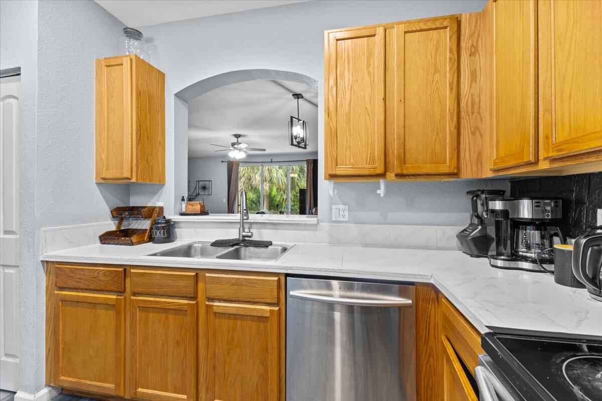 2227 Oakmont Drive Riviera Beach, FL 33404 - Photo 8 of 43 a kitchen with stainless steel appliances granite countertop a sink a stove and cabinets