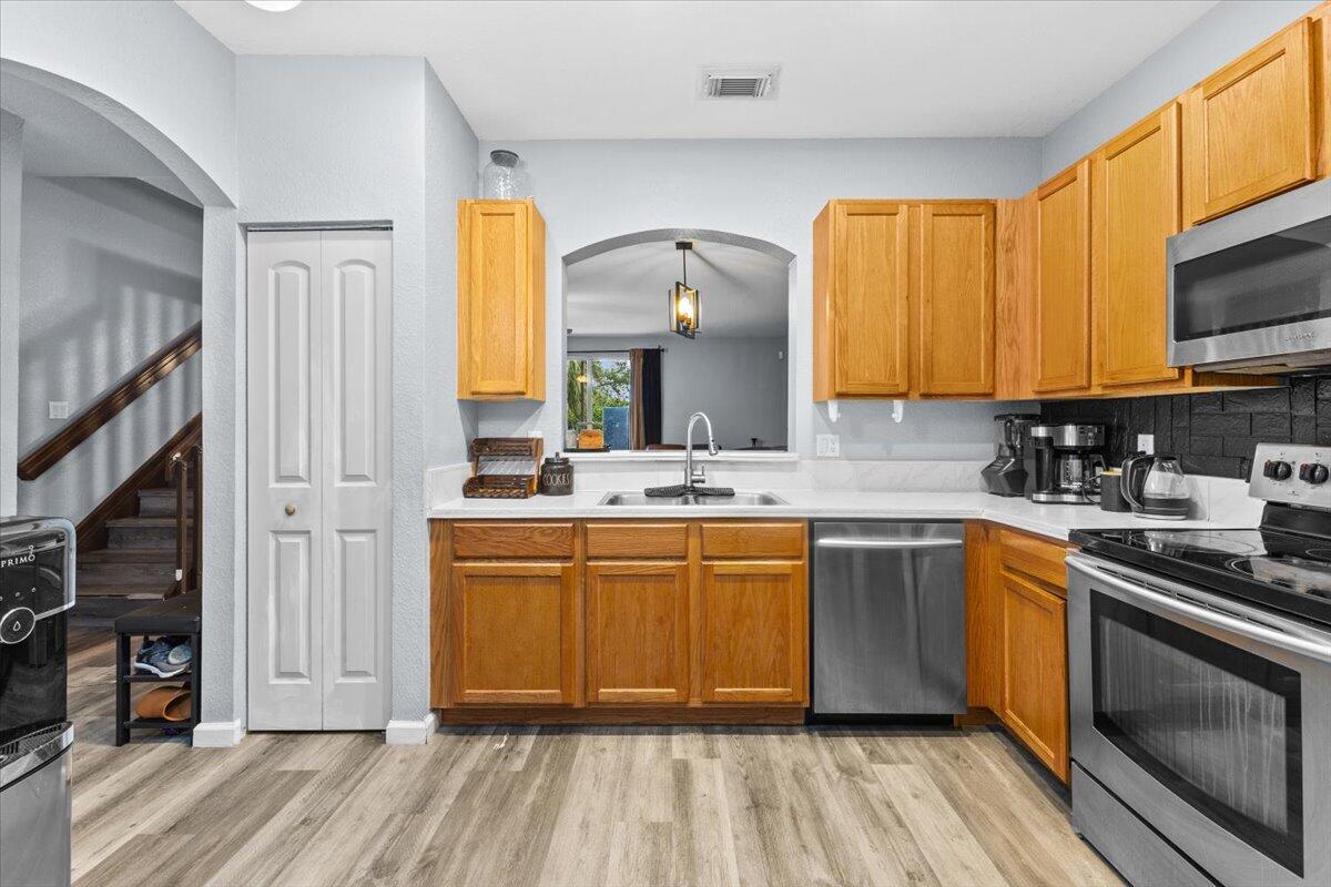 2227 Oakmont Drive Riviera Beach, FL 33404 - Photo 9 of 43 a kitchen with stainless steel appliances granite countertop a stove a sink and a microwave