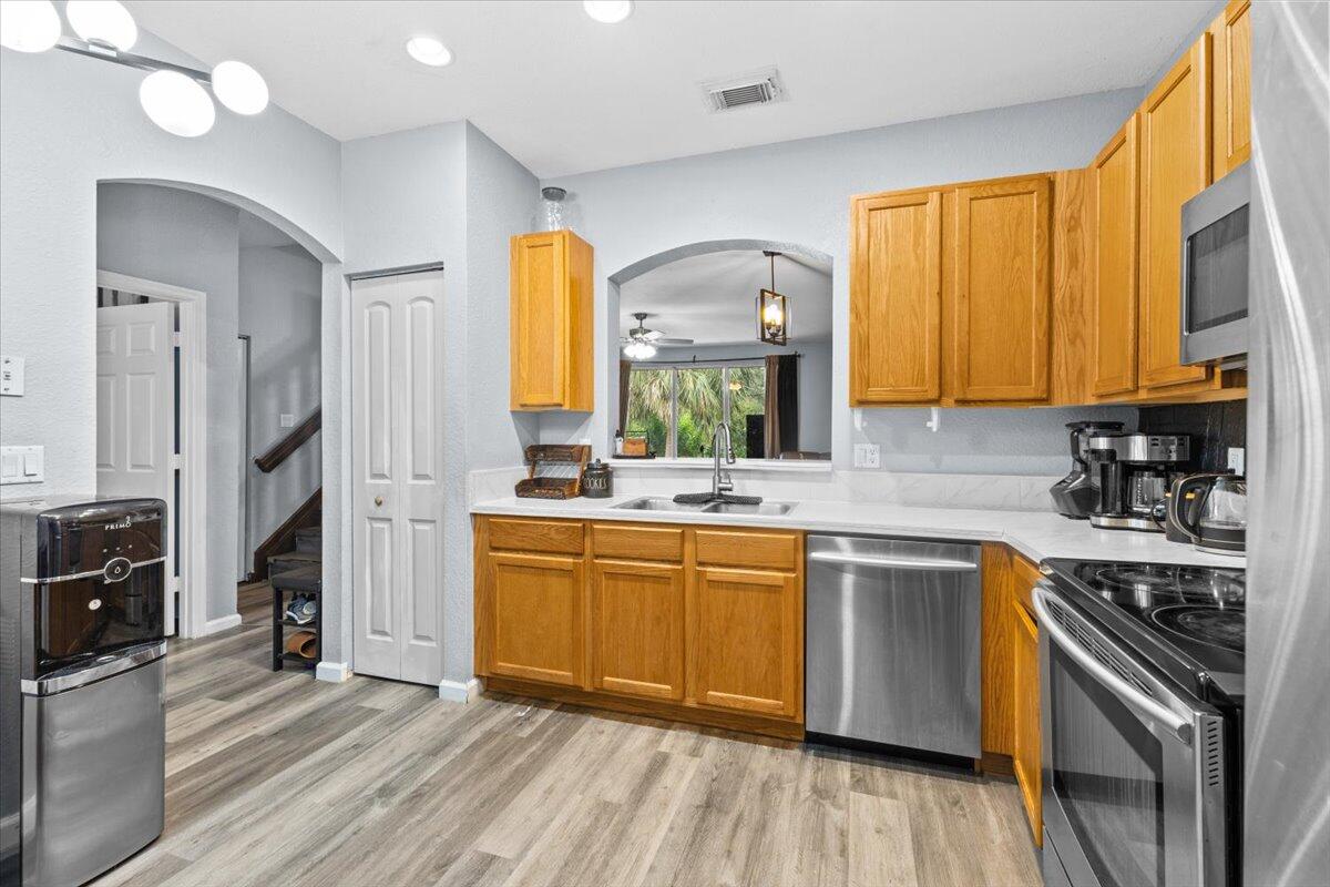 2227 Oakmont Drive Riviera Beach, FL 33404 - Photo 10 of 43 a kitchen with stainless steel appliances granite countertop a stove a sink dishwasher and a refrigerator