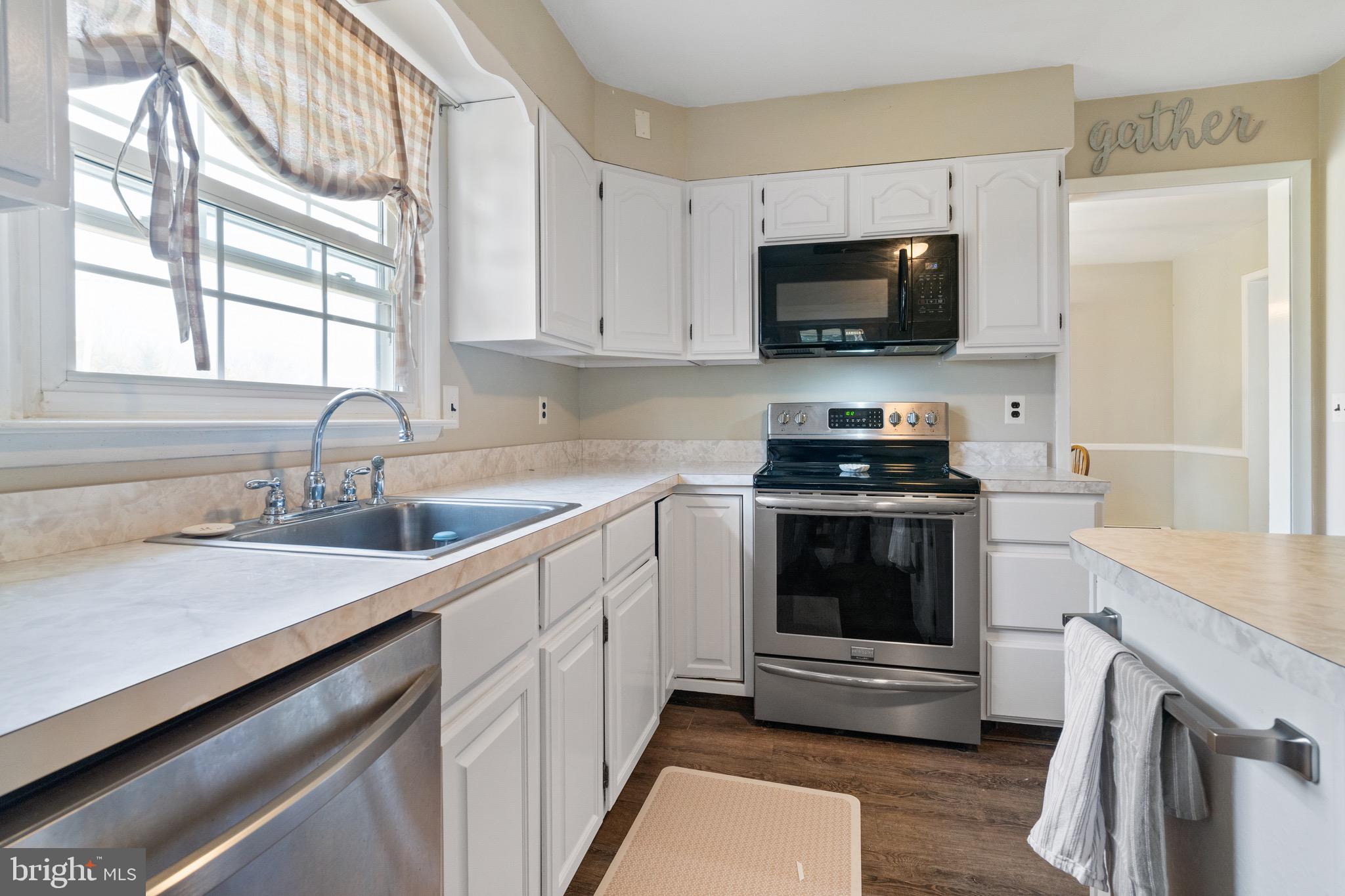 1204 Random Ridge Road Westminster, MD 21157 - Photo 13 of 33 a kitchen with granite countertop a sink and a stove top oven