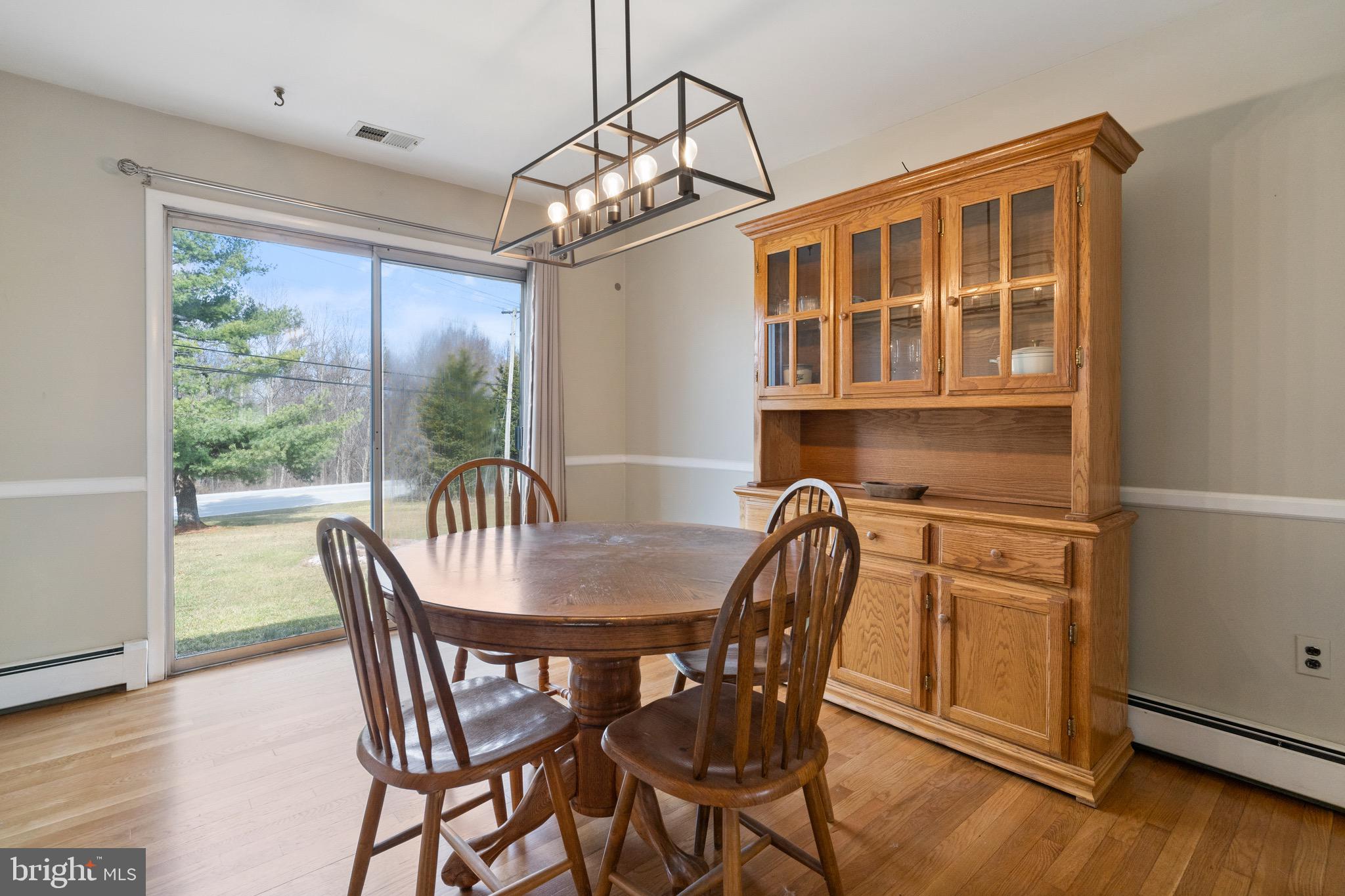 1204 Random Ridge Road Westminster, MD 21157 - Photo 9 of 33 a view of a dining room with furniture window and wooden floor