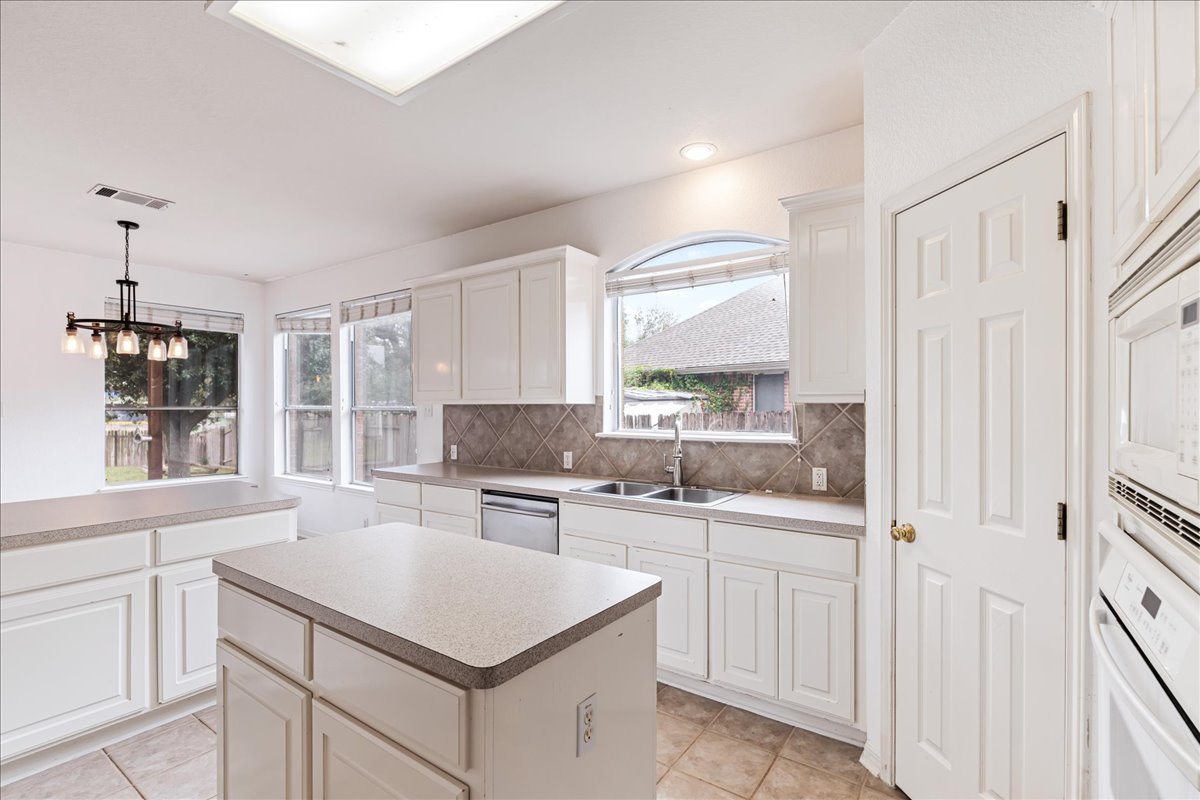 1253 Fall Creek Loop Cedar Park, TX 78613 - Photo 14 of 40 a kitchen with a sink stove and cabinets