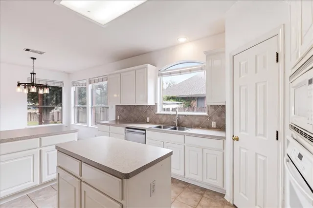 a kitchen with a sink stove and cabinets