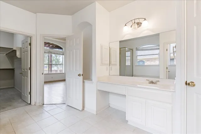 a bathroom with a sink a vanity and a mirror