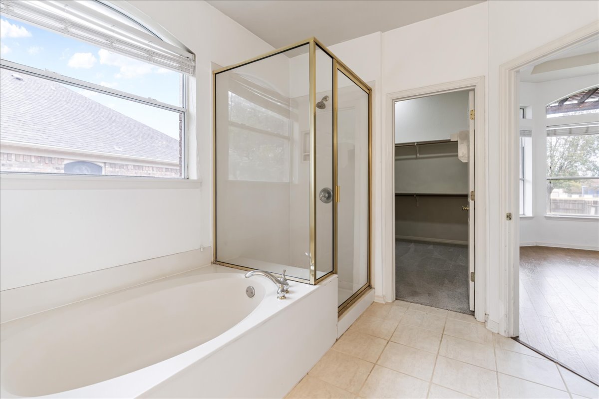 1253 Fall Creek Loop Cedar Park, TX 78613 - Photo 19 of 40 a bathroom with a bathtub and a shower