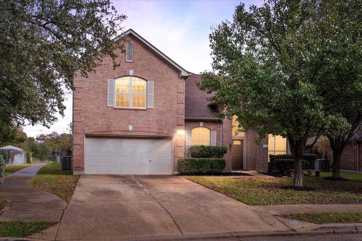 1253 Fall Creek Loop Cedar Park, TX 78613 - Photo 2 of 40 a front view of a house with a yard and garage