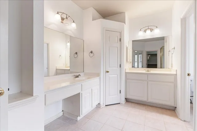 a spacious bathroom with a double vanity sink mirror and