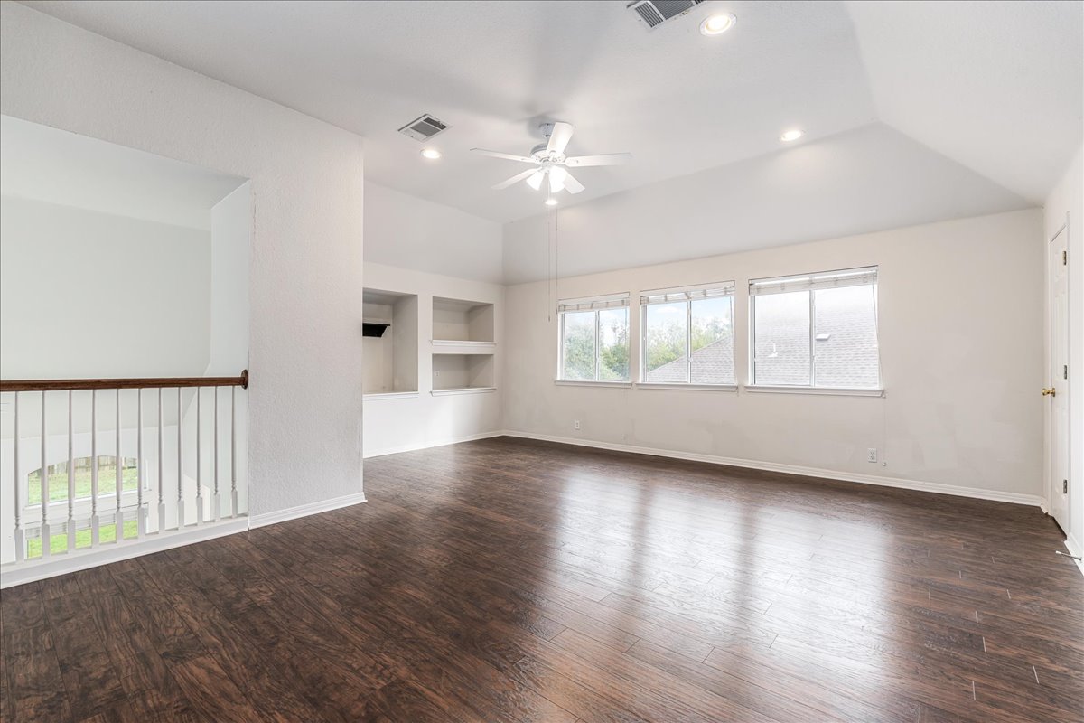 1253 Fall Creek Loop Cedar Park, TX 78613 - Photo 25 of 40 a view of an empty room with wooden floor and a window