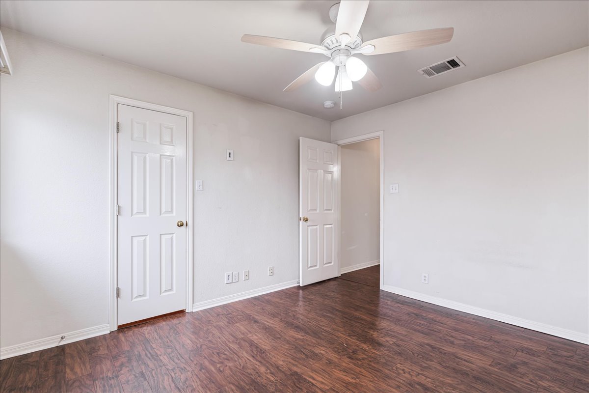 1253 Fall Creek Loop Cedar Park, TX 78613 - Photo 29 of 40 an empty room with wooden floor and fan