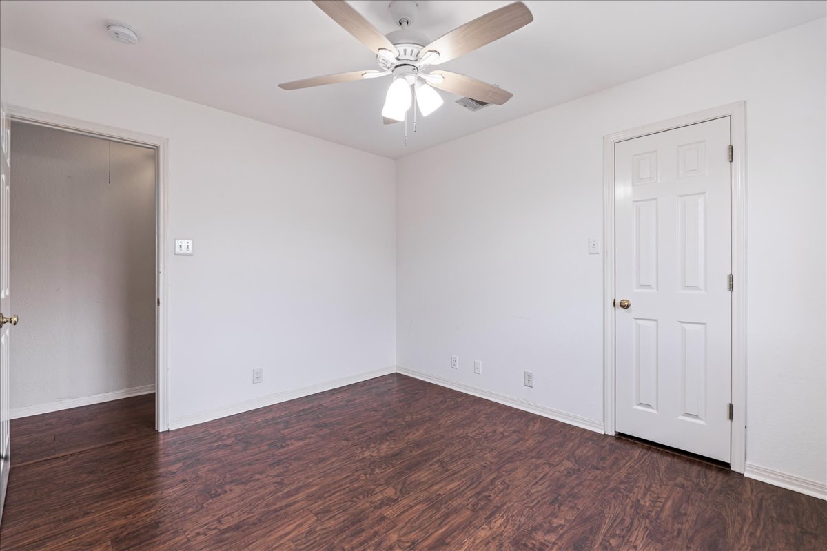 1253 Fall Creek Loop Cedar Park, TX 78613 - Photo 31 of 40 a view of a room with wooden floor and a ceiling fan