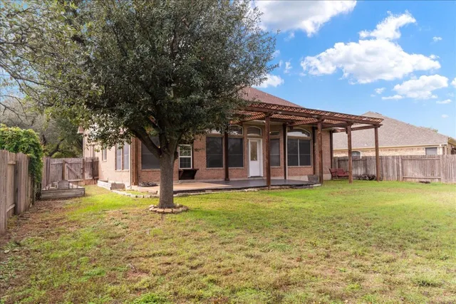 a view of a house with backyard and porch