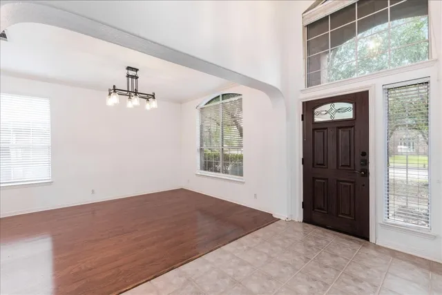 an empty room with windows and closet