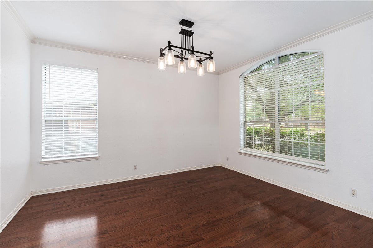 1253 Fall Creek Loop Cedar Park, TX 78613 - Photo 5 of 40 an empty room with wooden floor cabinet and windows