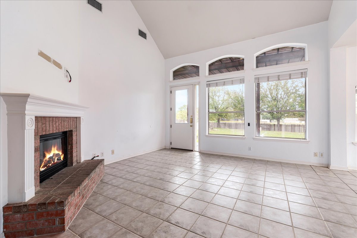 1253 Fall Creek Loop Cedar Park, TX 78613 - Photo 8 of 40 a view of an empty room with windows and a fireplace