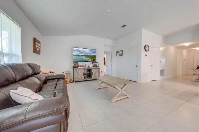 a view of a dining room with furniture and a chandelier