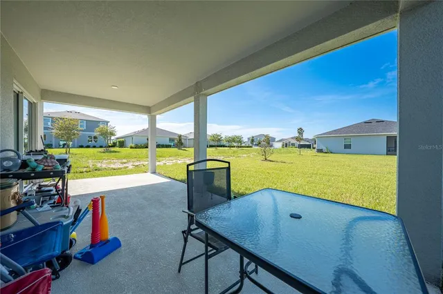 a view of a house with a backyard porch and sitting area