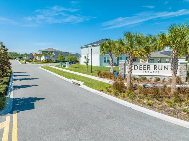 an aerial view of residential houses with outdoor space and swimming pool