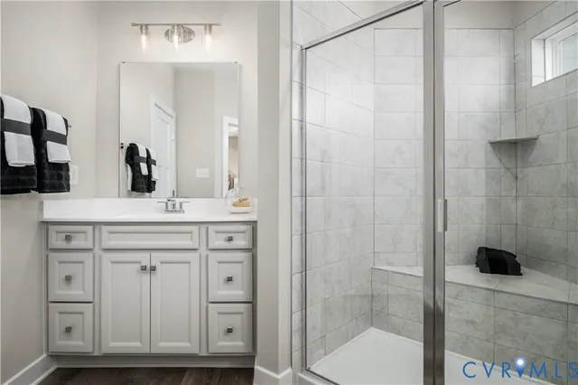 a bathroom with a shower sink and mirror