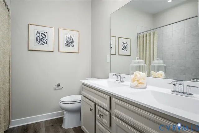 a bathroom with a sink a toilet and mirror