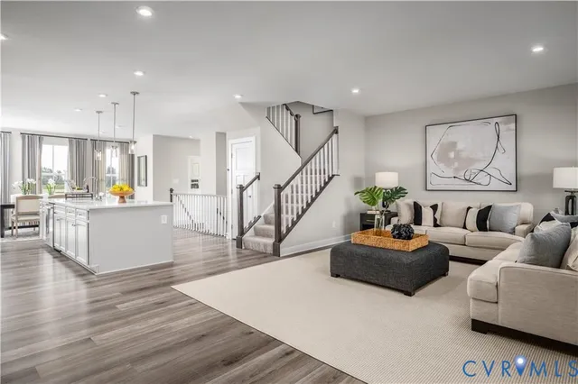 a living room with furniture and kitchen view