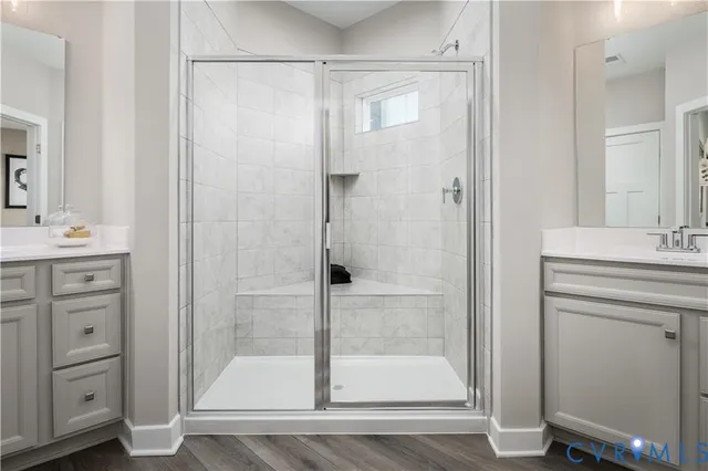 a bathroom with a shower sink and mirror