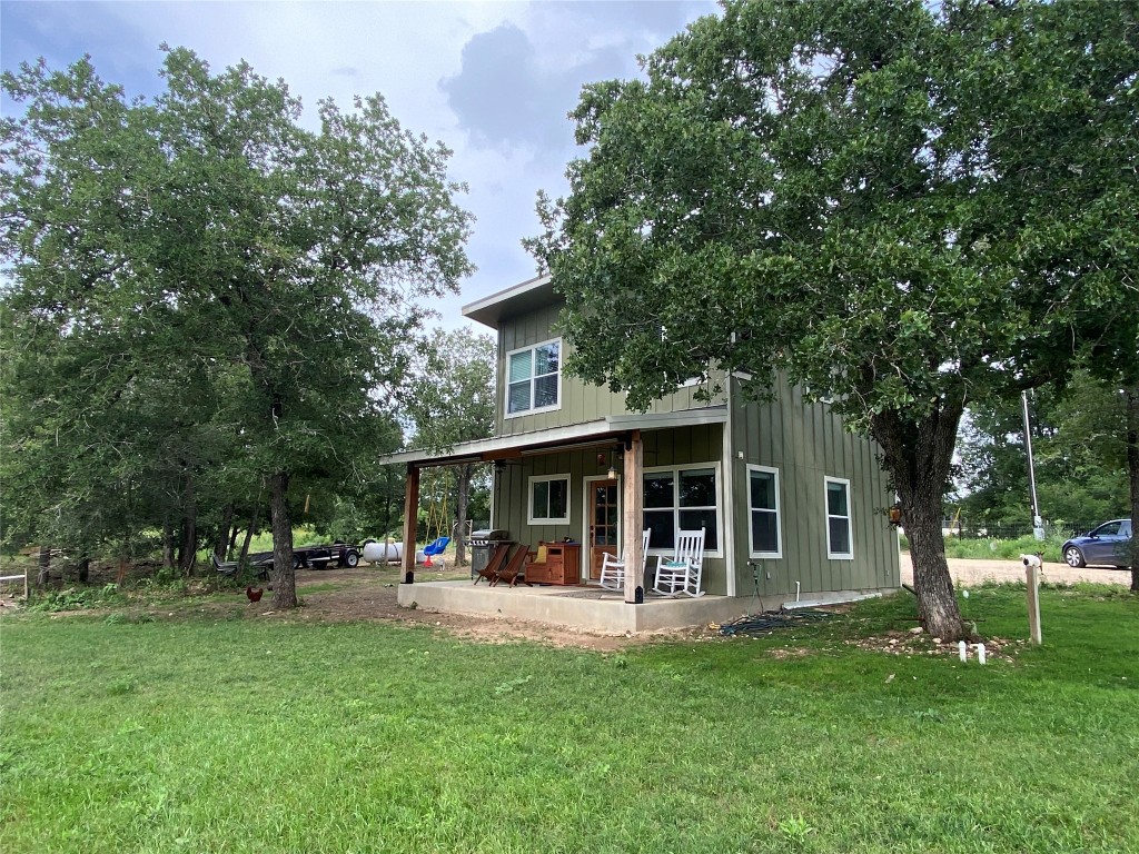 a view of a house with a yard porch and sitting area