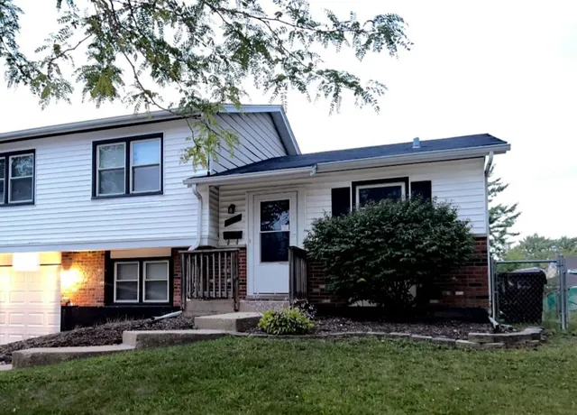 a front view of house with a garden