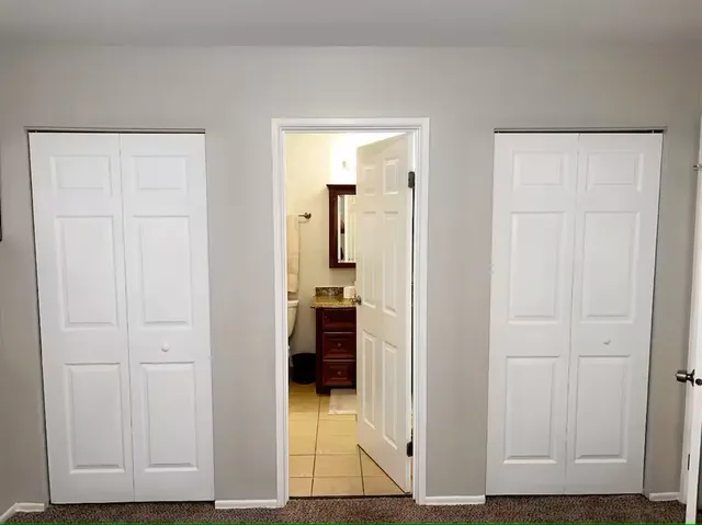 a view of a bedroom with a bed and a window