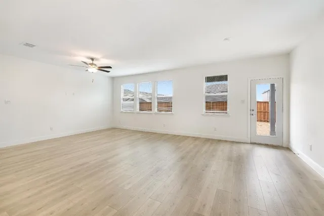 a kitchen with stainless steel appliances granite countertop a sink a stove a microwave a refrigerator a sink and cabinets