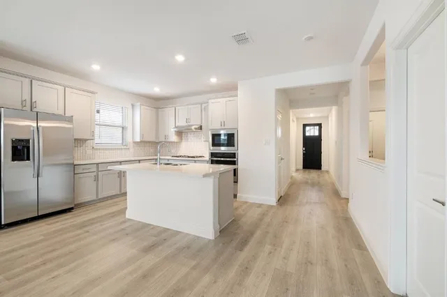 a kitchen that has a sink and cabinets