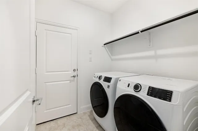 an empty room with windows and ceiling fan