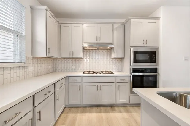 a spacious bathroom with a granite countertop sink and a mirror