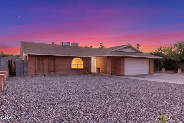 a front view of a house with a yard and a garage