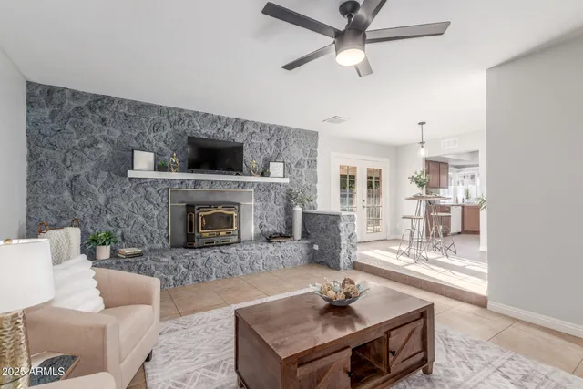 a living room with furniture a fireplace and a flat screen tv