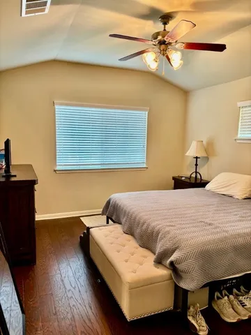 a bedroom with a bed and a night stand