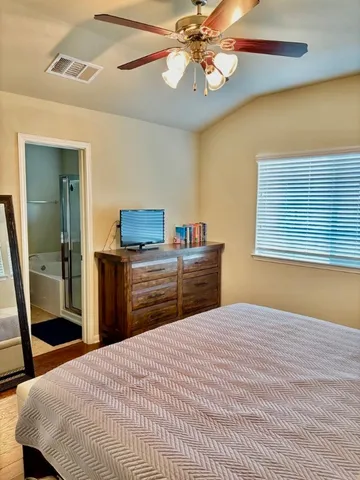 a bedroom with a bed and a tv