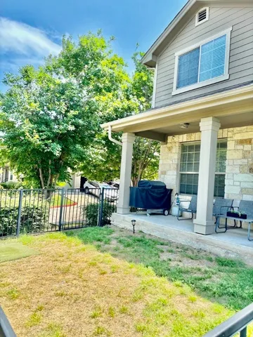 a view of backyard with a garden and deck