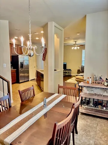 a dining room with furniture and a chandelier
