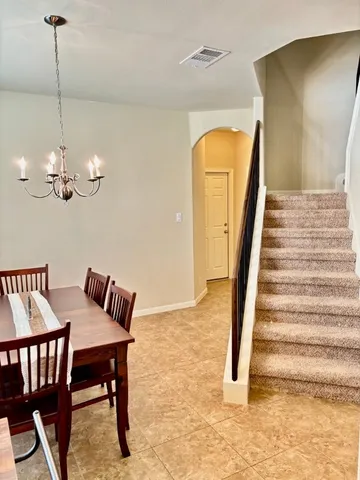 a view of a livingroom with furniture and staircase