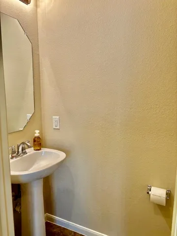 a bathroom with a sink a mirror and a toilet
