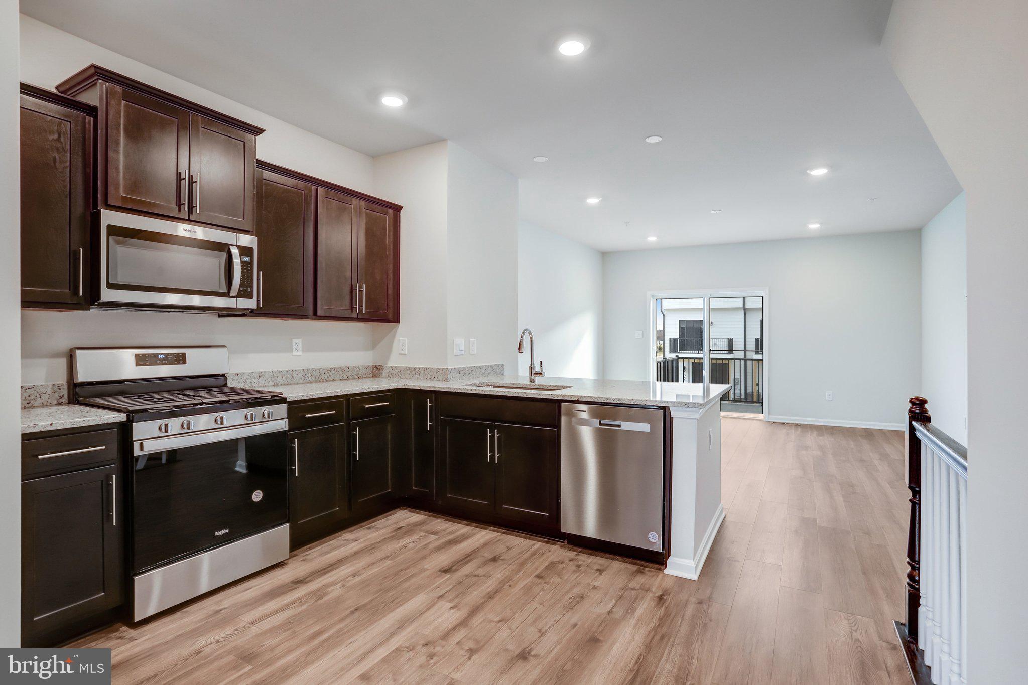 721 Courier Lane Frederick, MD 21701 - Photo 12 of 61 a kitchen with stainless steel appliances granite countertop a stove a sink and a refrigerator