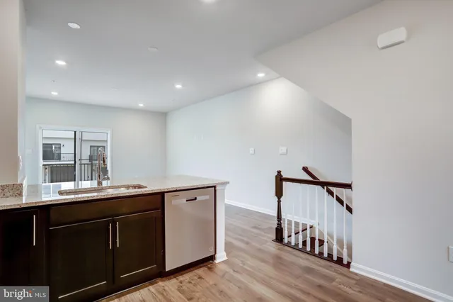 a kitchen with stainless steel appliances granite countertop a refrigerator a sink a stove and oven